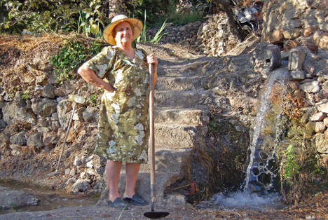 Eduarda takes a break from tending her garden