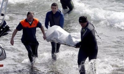 Rescue teams bring a body back to shore e