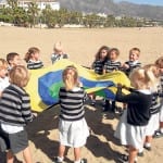 School children playing on beach