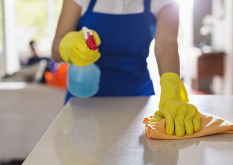 Woman cleaning kitchen co