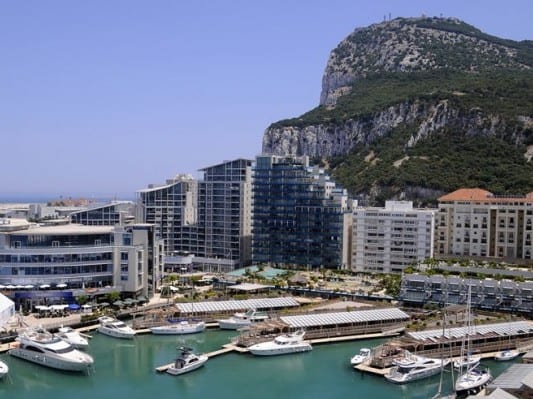 Ocean Village berths with rock behind e