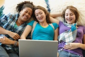 Teenage girls looking at laptop