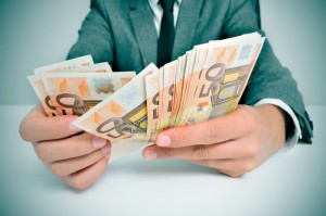 man in suit with counting euro bills