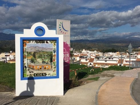 Coin sign overlooking town