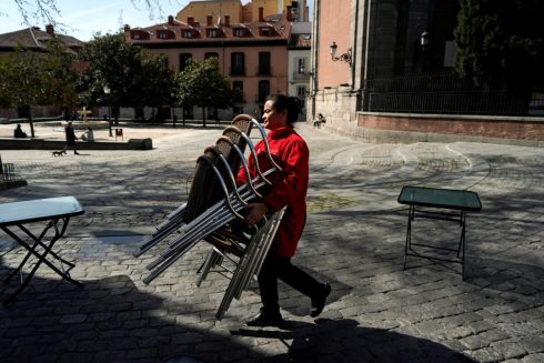 A Waitress Carries Chairs After The Town Hall Decreed The Closure Of The Terraces In Madrid