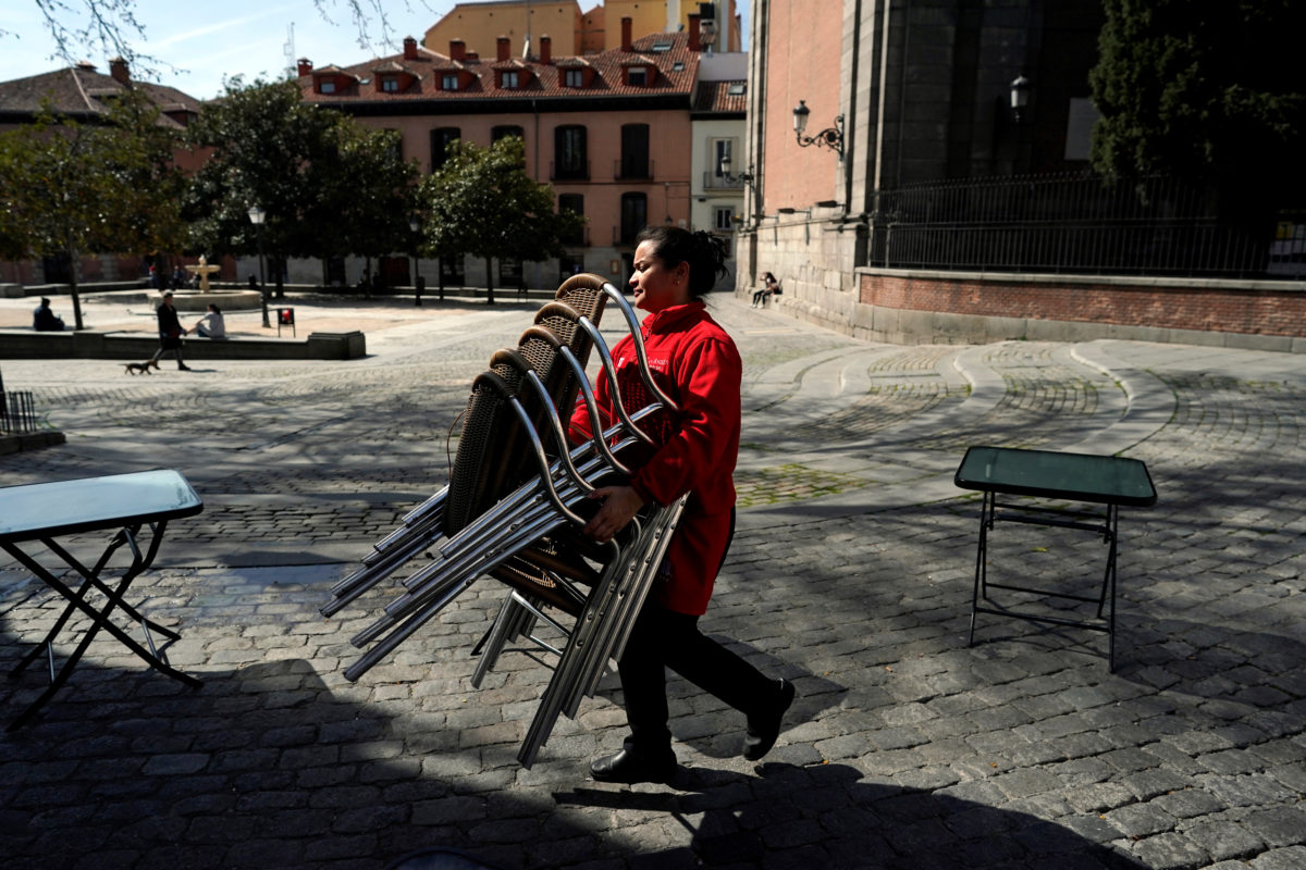 A Waitress Carries Chairs After The Town Hall Decreed The Closure Of The Terraces In Madrid