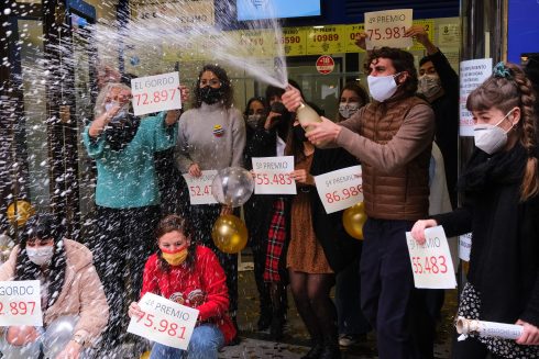 Lottery sellers show the winning numbers on Tuesday