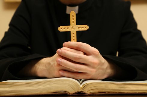 Priest Reading From The Holy Bible  Close Up