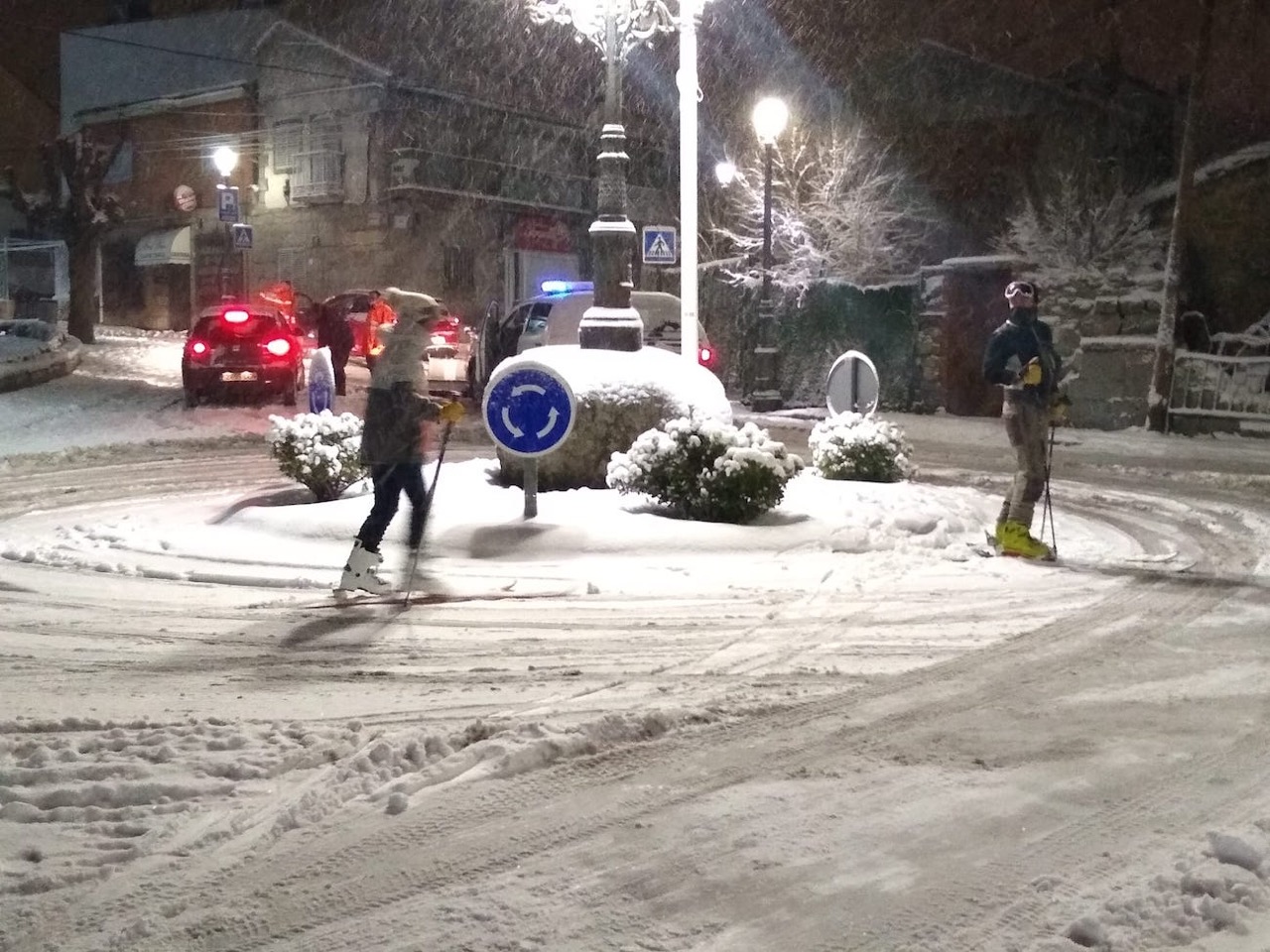 Skiers In Town Night