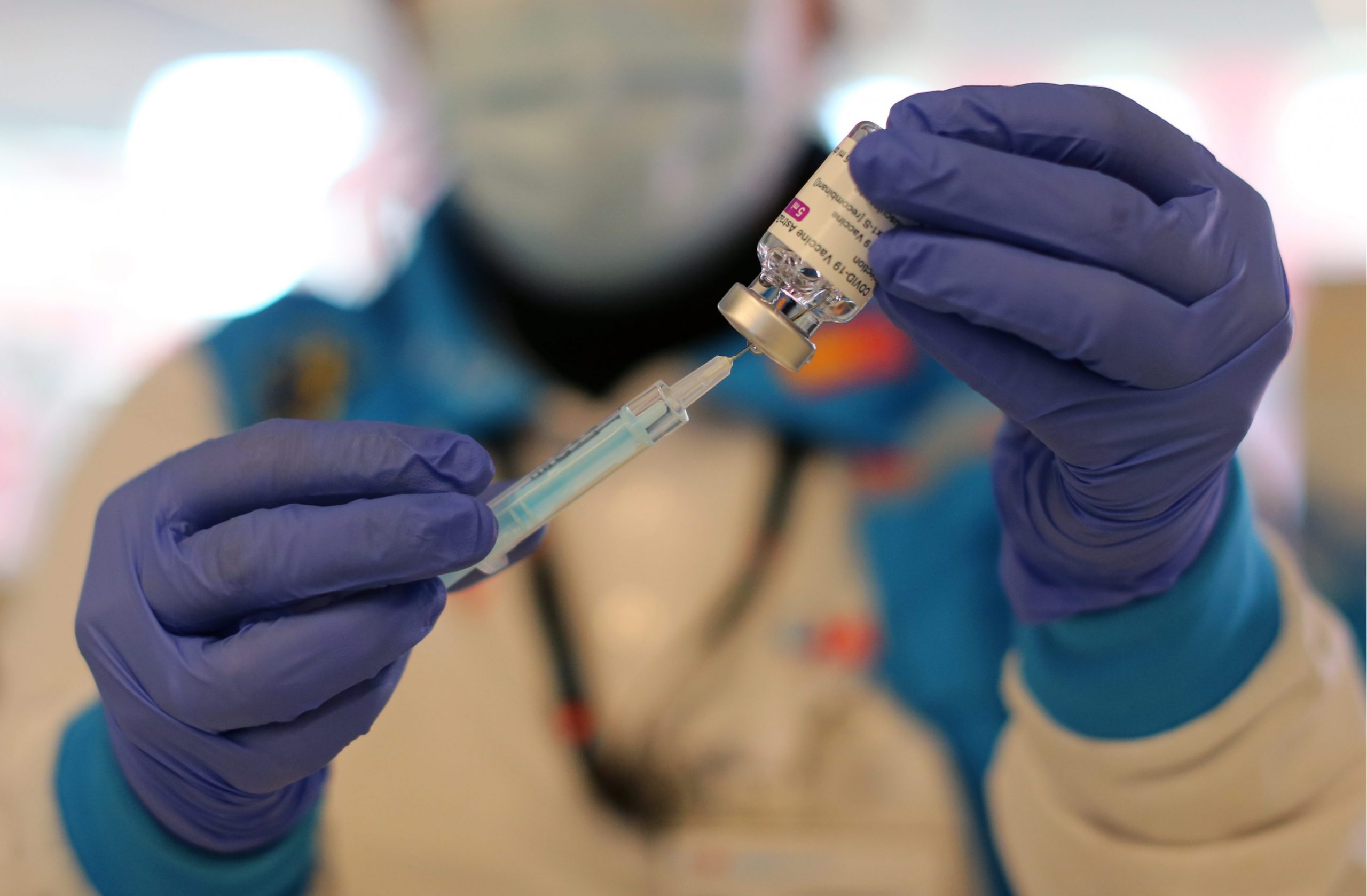 A sanitary worker preparing a dose of the AstraZeneca COVID vaccine