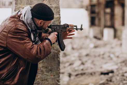 Terrorist With Gun Fighting With Soldiers