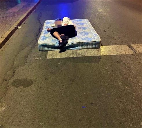 Time for bed as police find man sleeping on mattress in middle of the street in Spain's Murcia region