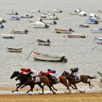 Jockeys Ride During A Race Along The Beach In Sanlucar De Barrameda