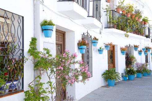 Picturesque Street Of Mijas With Flower Pots In Facades, A Tradi