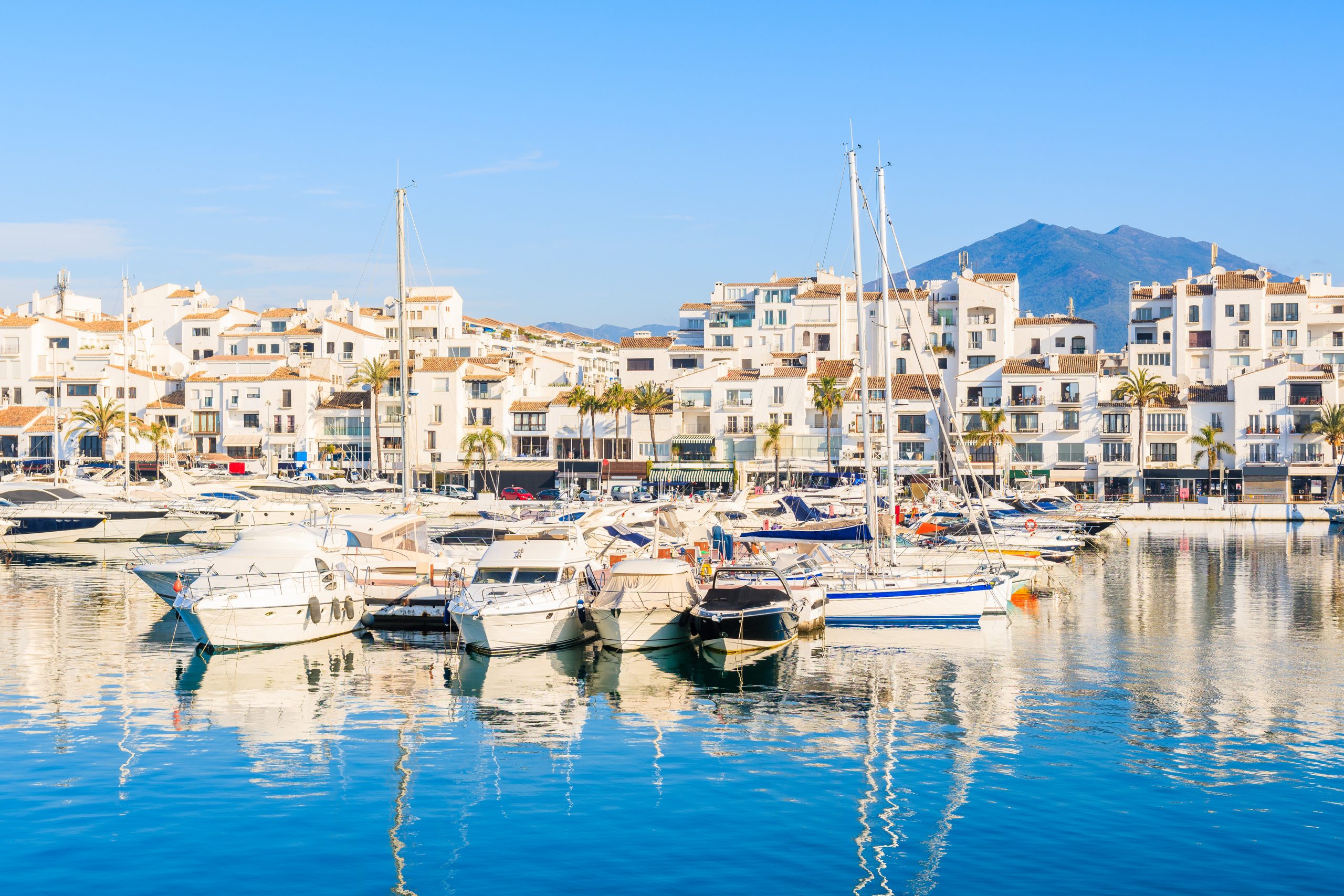 View Of Puerto Banus Marina With Boats And White Houses In Marbe