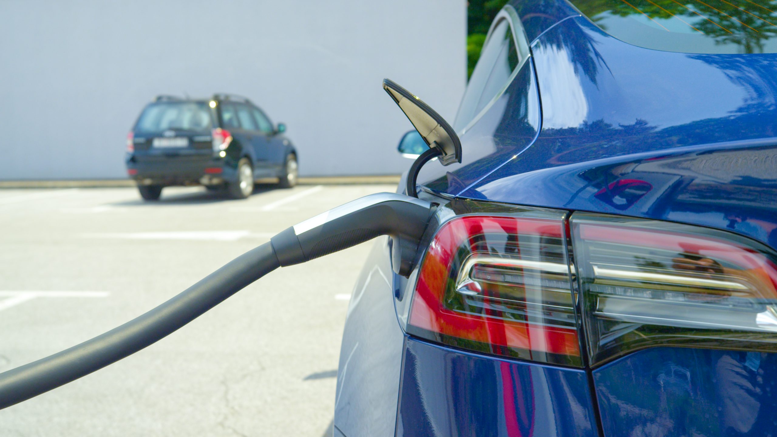 Close Up: Detailed Shot Of A Shiny New Tesla Car Recharging At A