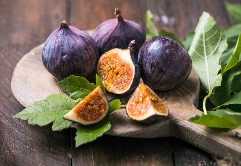 Ripe Fig Fruits With Fig Leaves On The Wooden Background