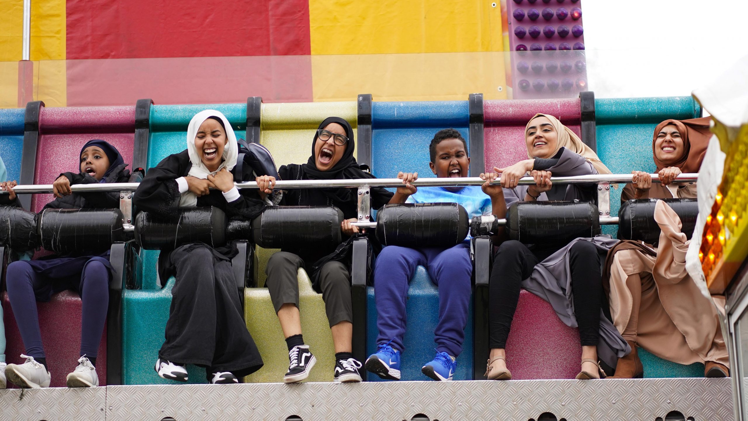 People enjoy theme park rides at a funfair on Eid Al Fitr 2022