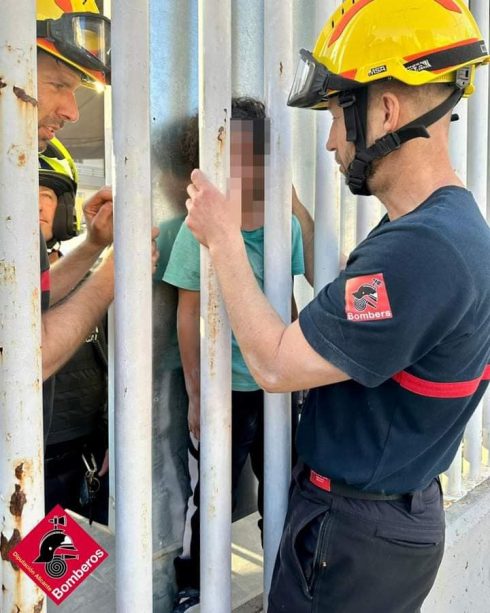 Fire Crew In Spain's Benidorm Rescue Child Trapped Between Iron Fence And Advertising Billboard