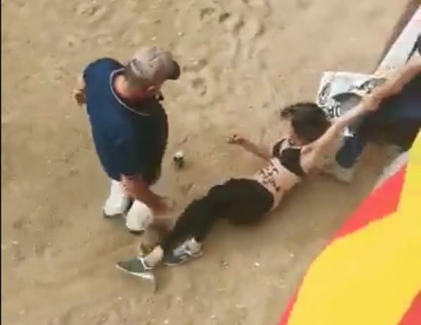 Bullfighting protestor is dragged out of the ring