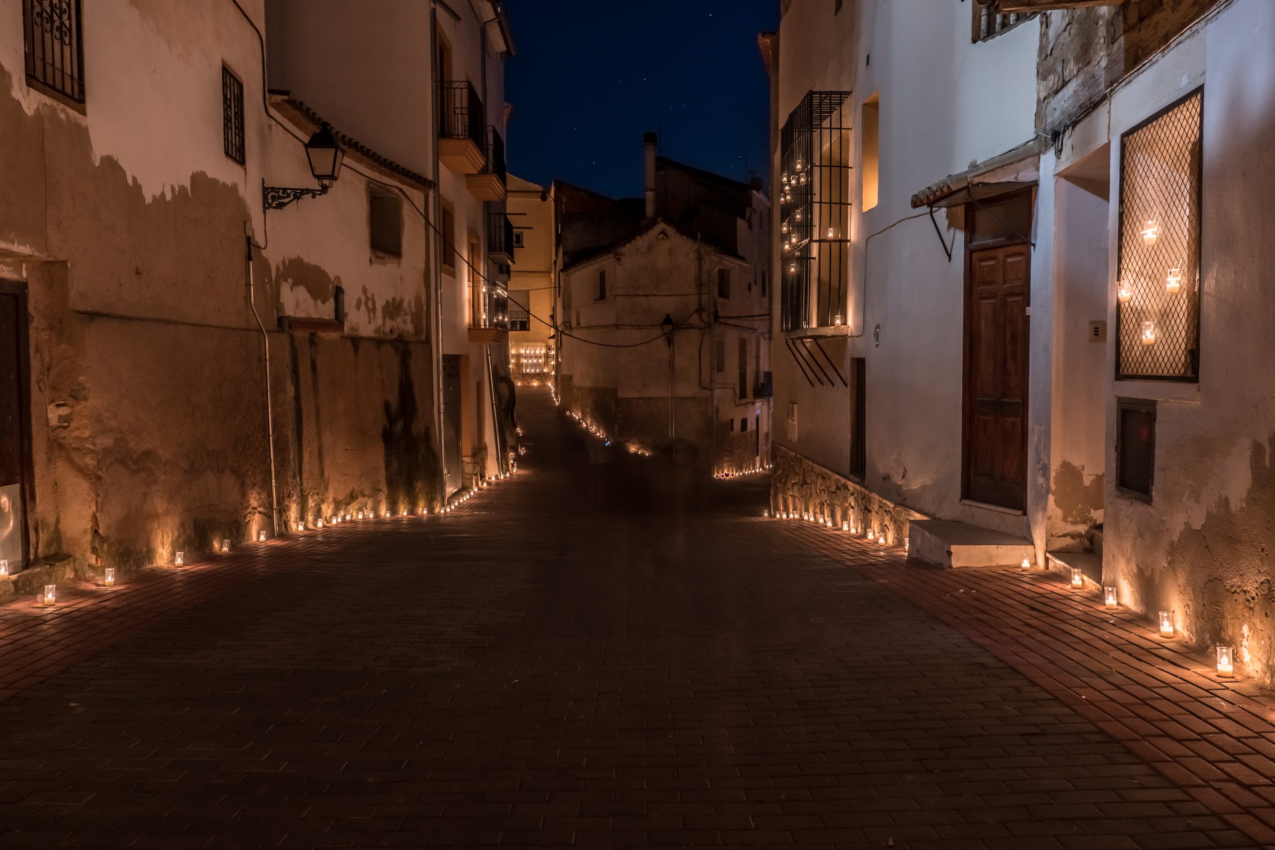 Titaguas,village,,streets,illuminated,by,candles,drawing,shapes,on,the