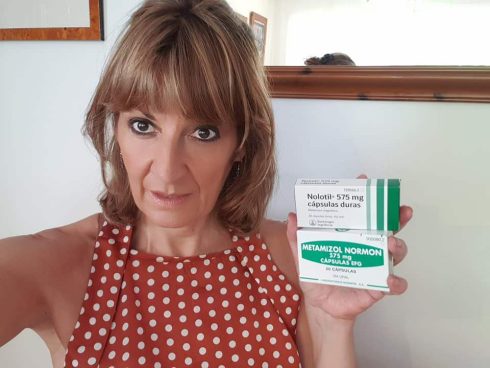 A woman holding two boxes of Nolotil medication 