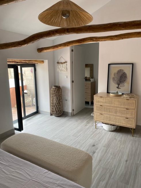 AFTER: Area of house transformed into a bedroom with the original beams intact 