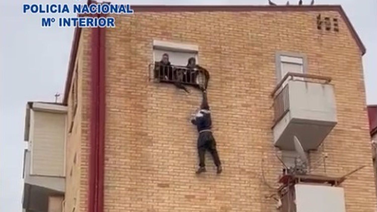 Police rescue robber who clung onto top floor window railing with one hand in Spain's Murcia