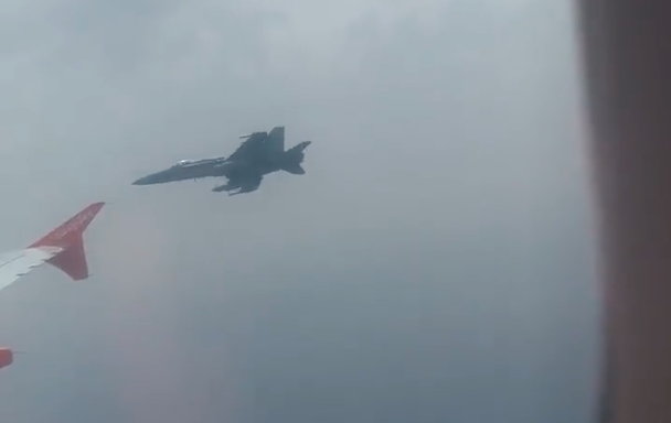 fighter escorts passenger plane