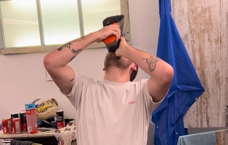 Tom Hopcroft does a 'shoey' at the end of the Camino de Santiago