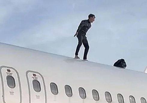 WATCH: Alarming moment young man with suspicious backpack climbs onto roof of plane parked at major Spanish airport