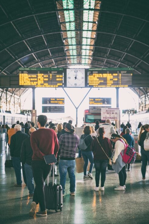 Travelers waiting for their trains at a train station in Valencia, Spain.