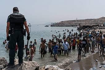 Migrants in Ceuta walking out of the sea