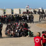 The Spanish army corrals migrants on a Ceuta beach