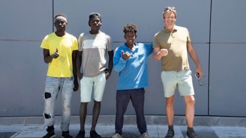 3 young migrants and Jon Clarke