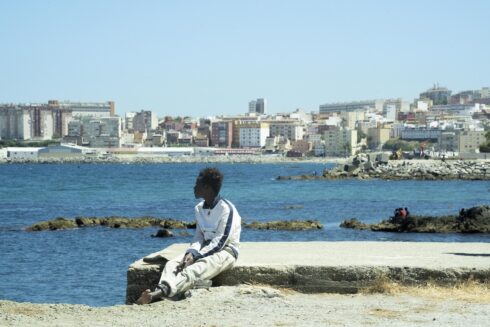 An african man looks out to see from a dock