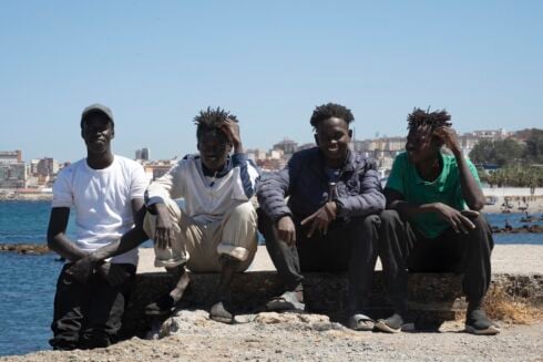 Four african men pose for a photograph