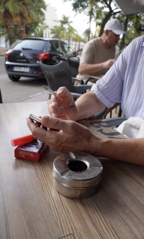 Man smoking a cigarette at a bar in southern Spain