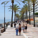 People are walking down a playa in Marbella, Spain