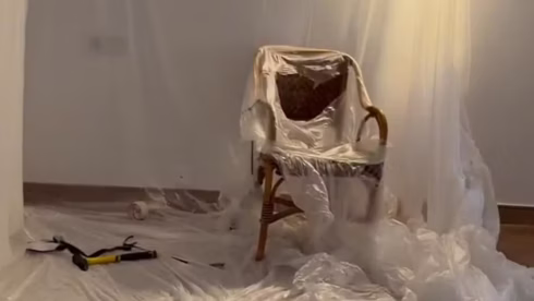 A plastic covered chair surrounded by tools