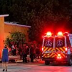 An ambulance outside an orange building