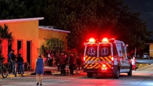 An ambulance outside an orange building