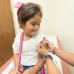 A young girl being vaccinated