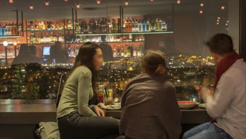 A couple overlooking Barcelona at night time