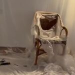 A plastic covered chair surrounded by tools
