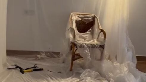 A plastic covered chair surrounded by tools