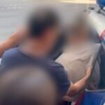 A blurred image of a man being arrested the mossos d' escuadra in Barcelona