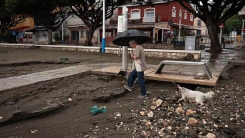 Person walking in heavy rain in Malaga