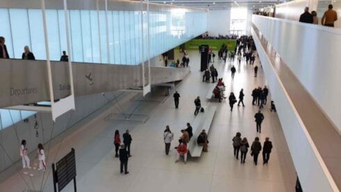 Inside Corvera Airport, where people are walking through the departure terminal